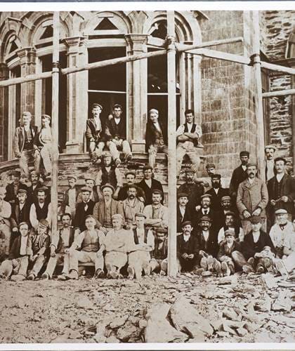 People standing in front of the hotel while it was being built